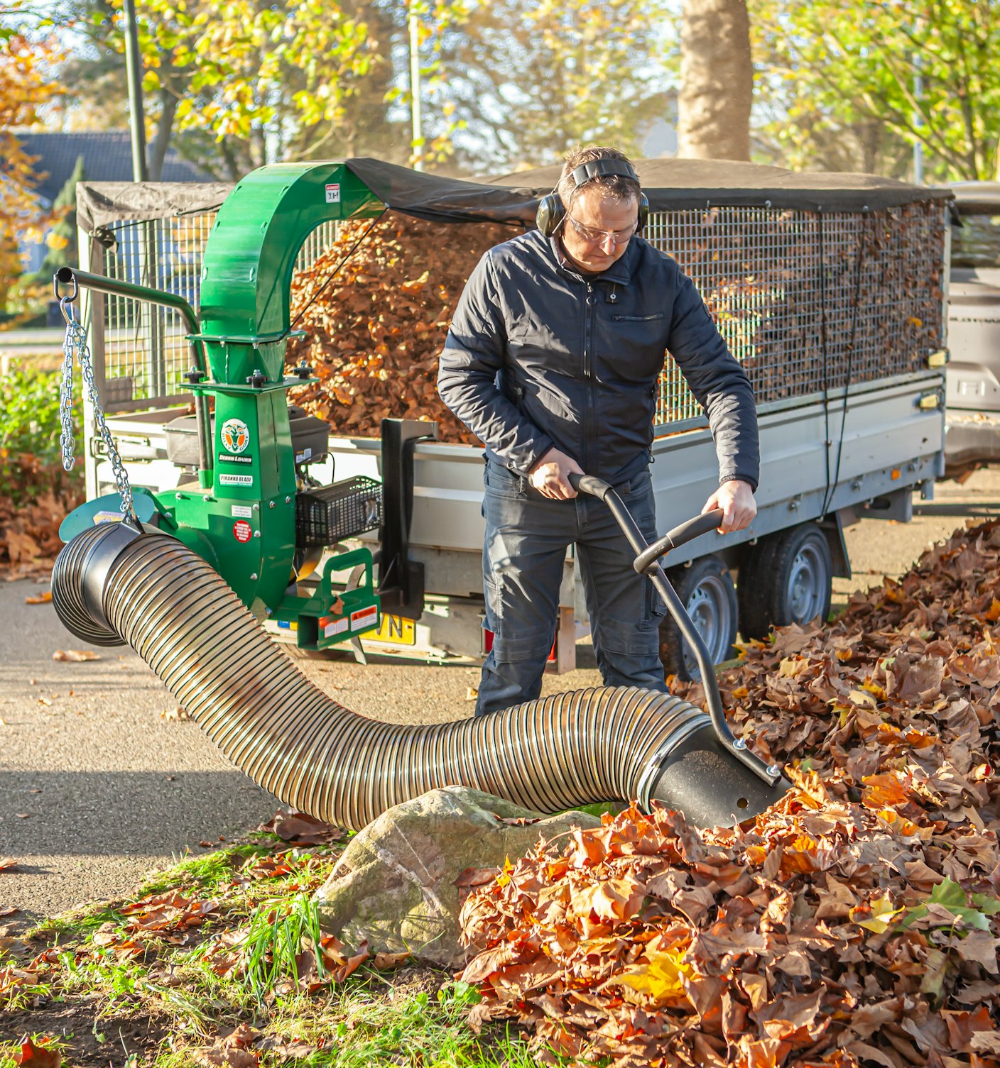 Man utilising debris loader for autumn cleanup