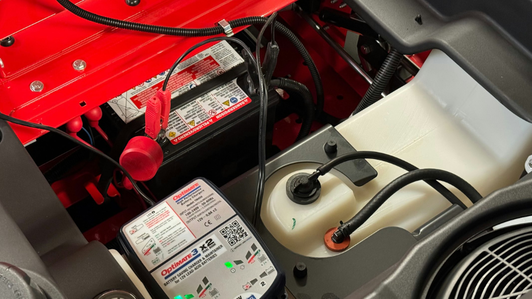 Trickle charger attached to zero turn mower lead-acid battery