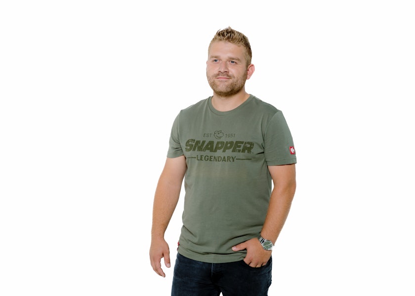 Fair haired man wears Snapper T shirt front facing looking to left